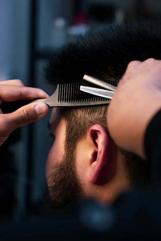 Barber trimming with shears