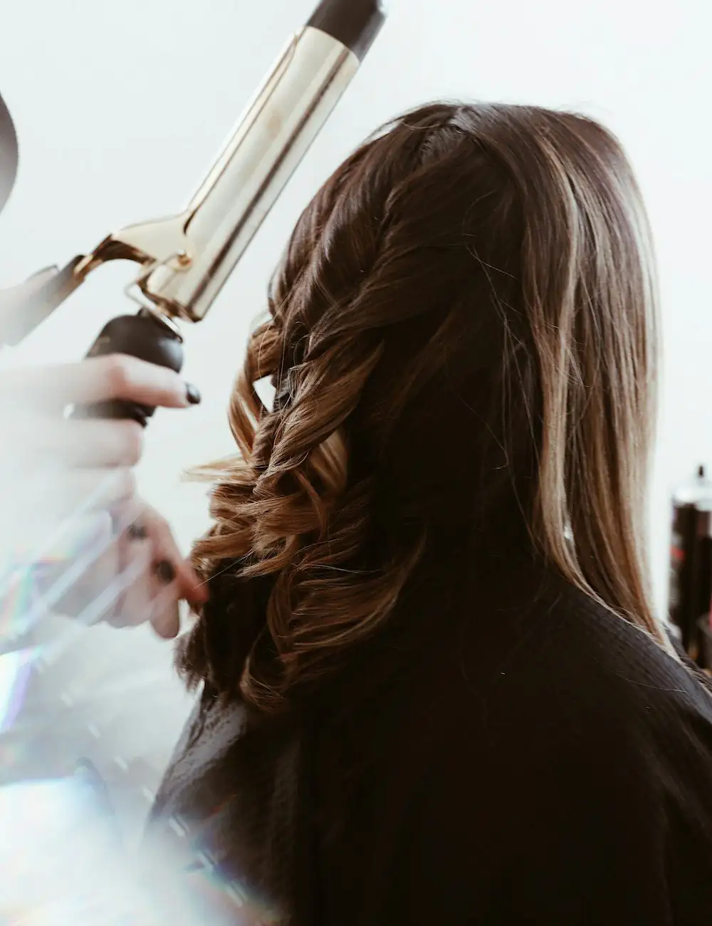 Stylist finishing a client's blow dry at Lumaa Beauty Lounge